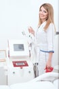 Beautiful cosmetician at her working place is going to apply procedure of laser epilation or rf lifting