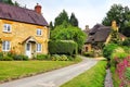 Beautiful Cotswolds village with thatched roof house and flowers, England Royalty Free Stock Photo