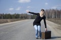 Beautiful country girl hitchhiking on the road Royalty Free Stock Photo