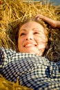 Beautiful country girl lying on the haystack Royalty Free Stock Photo