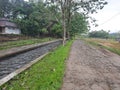 Beautiful country road with a river flowing beside it. Natural concept. In indonesia