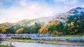 Beautiful country small village near the river with beautiful nature hills and colors leaves trees blue sky background in autumn Royalty Free Stock Photo