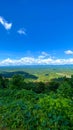 Beautiful sunny countryside springtime landscape in mountains. Grassy field rolling hills. Green mountains and beautiful sky. Royalty Free Stock Photo