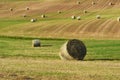 Beautiful countryside landscape near Siena in Tuscany, Italy. Round straw bales hay balls in harvested fields and blue sky. Royalty Free Stock Photo