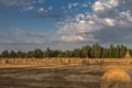 Beautiful Countryside Landscape: Golden Hay Bales in Harvested Fields and Blue Sky with Clouds Royalty Free Stock Photo