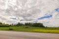 Beautiful countryside landscape view on bright summer day. Green fields under white clouds. Royalty Free Stock Photo