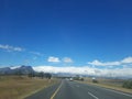 beautiful countryside landscape view with grass on the side and white clouds Royalty Free Stock Photo