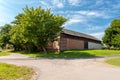 Beautiful countryside on a sunny day. A large old barn at the crossroads of rural streets. A small peaceful quiet village. Cisowo Royalty Free Stock Photo