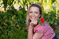 Beautiful countrywoman with flower in her garden