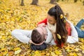Beautiful couple in autumn park lying on the ground