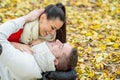 Beautiful couple in autumn park lying on the ground Royalty Free Stock Photo