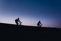 Beautiful Couple on bicycles silhouette sunset two bike ride Royalty Free Stock Photo