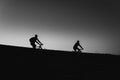 Beautiful Couple on bicycles silhouette sunset two bike ride, black and white Royalty Free Stock Photo