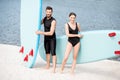 Couple with standup paddleboard on the beach
