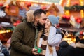 boyfriend give a present gift box to a girlfriend on Christmas fair in Wroclaw, Poland