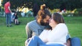 Beautiful couple caressing sitting on green grass in park. Concept. Happy young couple hugging on green grass in sun Royalty Free Stock Photo