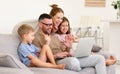 Father, mother and two cute children talking with family online Royalty Free Stock Photo
