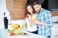Beautiful couple cooking healthy food on the kitchen Royalty Free Stock Photo
