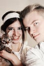 Beautiful couple with cute funny kitten with bow tie on white ba Royalty Free Stock Photo