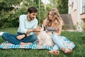 Beautiful couple with a dog on the grass