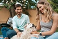 Beautiful couple with a dog on the grass