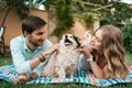 Beautiful couple with a dog on the grass