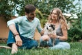 Beautiful couple with a dog on the grass
