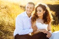 Beautiful couple in field, Lovers or newlywed posing on sunset with perfect sky