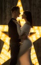 Beautiful couple in front of a glowing star. Pregnancy.