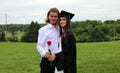 Beautiful couple and girl in black Cap, Gown and Tass, teenager. Unique gorgeous face, nice smile, wonderful eyes girl. Royalty Free Stock Photo