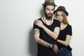 Beautiful couple in hat together. Hipster boy and girl. Bearded young man and blonde. Tattoo Royalty Free Stock Photo