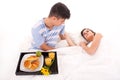 Beautiful couple having breakfast lying in the bed Royalty Free Stock Photo