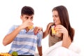 Beautiful couple having breakfast lying in the bed Royalty Free Stock Photo