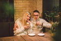 Beautiful couple having coffee on a date,having fun together. Couple young people drinking coffee in stylish modern cafeteria. Royalty Free Stock Photo