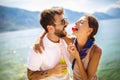 Couple having fun on the beach, drinking cocktails and smiling Royalty Free Stock Photo