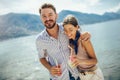 Couple having fun on the beach, drinking cocktails and smiling Royalty Free Stock Photo