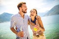 Couple having fun on the beach, drinking cocktails and smiling Royalty Free Stock Photo