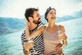 Couple having fun on the beach, drinking cocktails and smiling Royalty Free Stock Photo