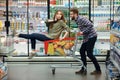 Beautiful couple having fun while choosing food in the supermarket Royalty Free Stock Photo