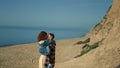 Beautiful couple holding hands walking sea shore. Happy lovers hugging kissing. Royalty Free Stock Photo