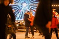 Beautiful Couple Ice Skating In City Centre. Young couple skating at a public ice skating rink outdoors. Theme ice skating rink Royalty Free Stock Photo