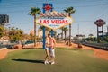 Beautiful couple kissing by the Las Vegas sign in Nevada