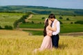 Beautiful couple kissing on nature in a yellow field of wheat in Royalty Free Stock Photo