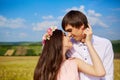 Beautiful couple kissing on nature in a yellow field of wheat in Royalty Free Stock Photo