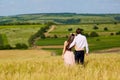 Beautiful couple kissing on nature in a yellow field of wheat in Royalty Free Stock Photo