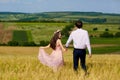 Beautiful couple kissing on nature in a yellow field of wheat in Royalty Free Stock Photo