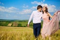 Beautiful couple kissing on nature in a yellow field of wheat in Royalty Free Stock Photo