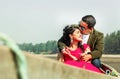 Beautiful couple kissing while sitting on rowboat at beach Royalty Free Stock Photo