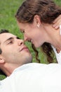 Beautiful couple laying in grass looking into each Royalty Free Stock Photo