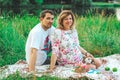 Beautiful couple in love on the background of the lake in the park in summertime closeup